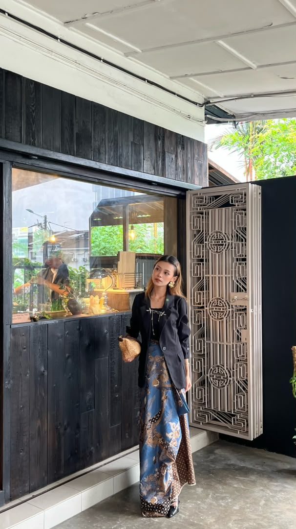 Bella Arbaín in batik and a blazer on location